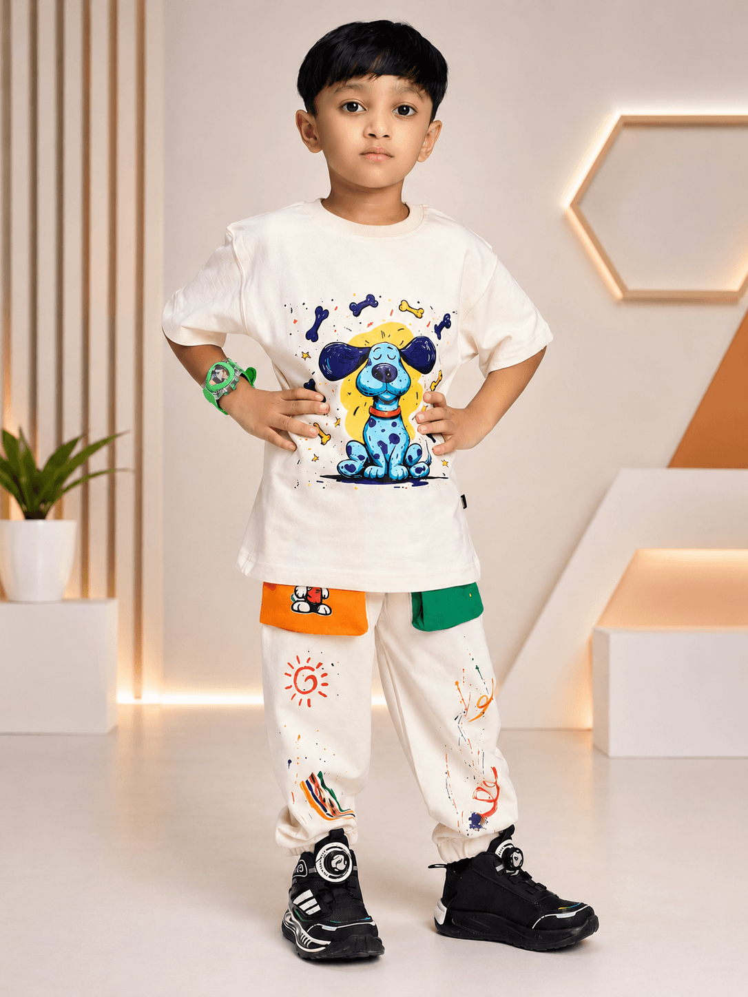 CUTE BLUE PUPPY PRINT CO-ORD FOR BOYS GIRLS OFF WHITE worn by a young boy in a stylish room.