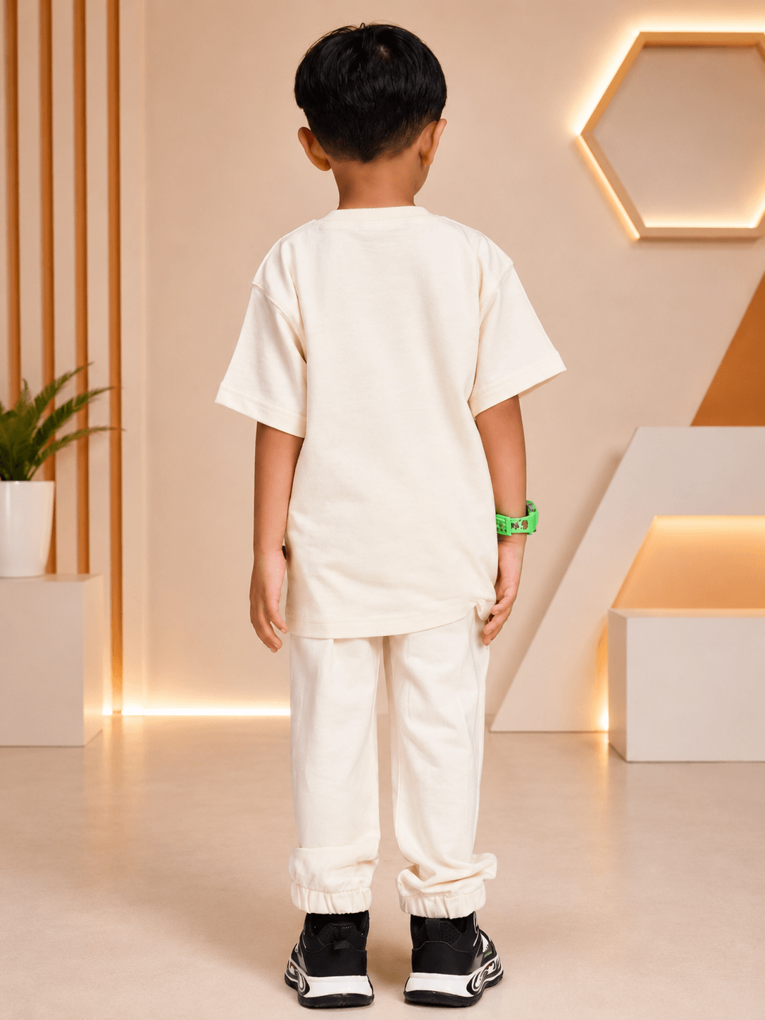 Cute blue puppy print co-ord for boys girls off white styled with a child wearing a casual outfit from the back.