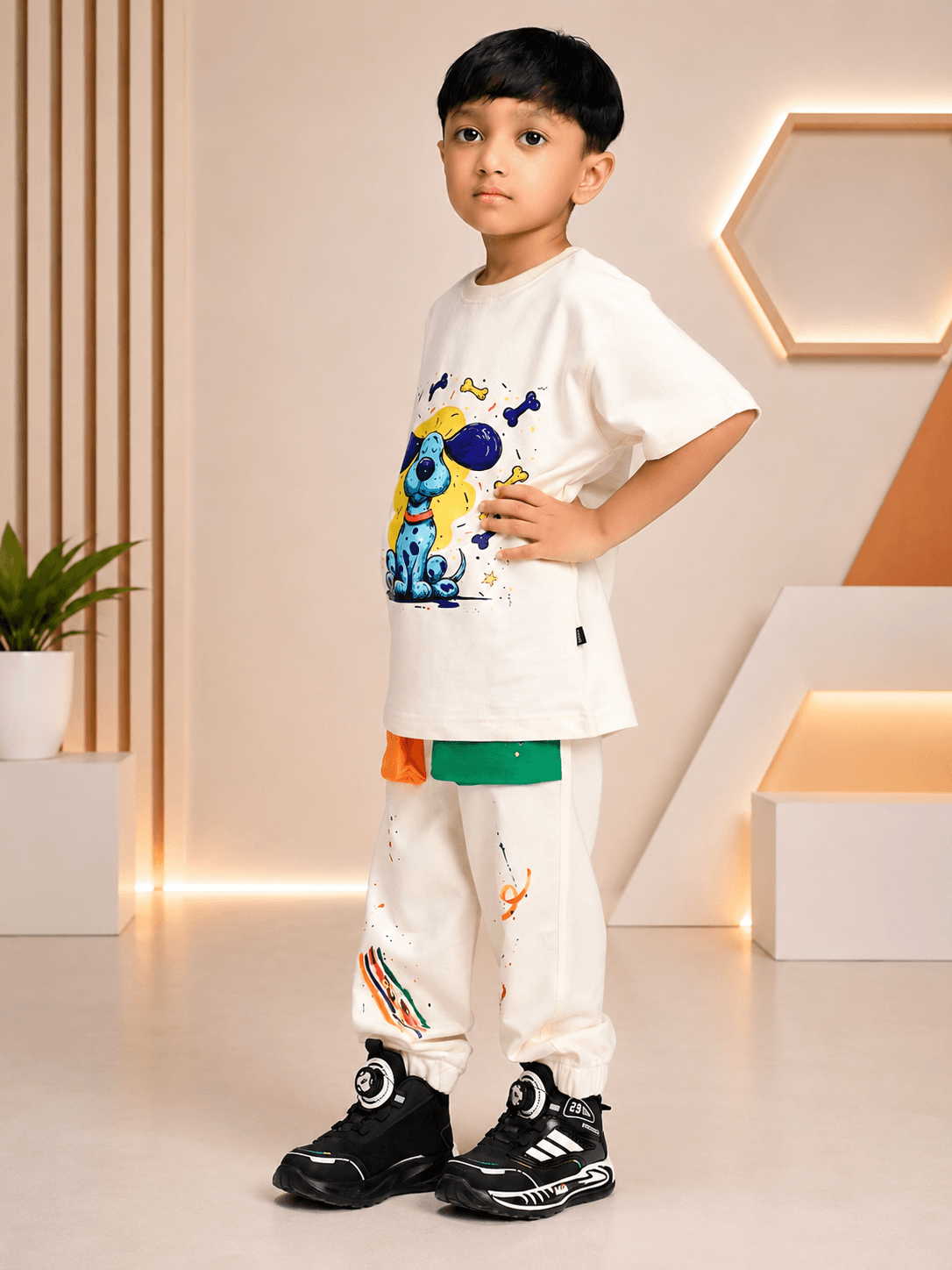 Cute blue puppy print co-ord for boys girls off white worn by a young boy in a stylish and playful pose.