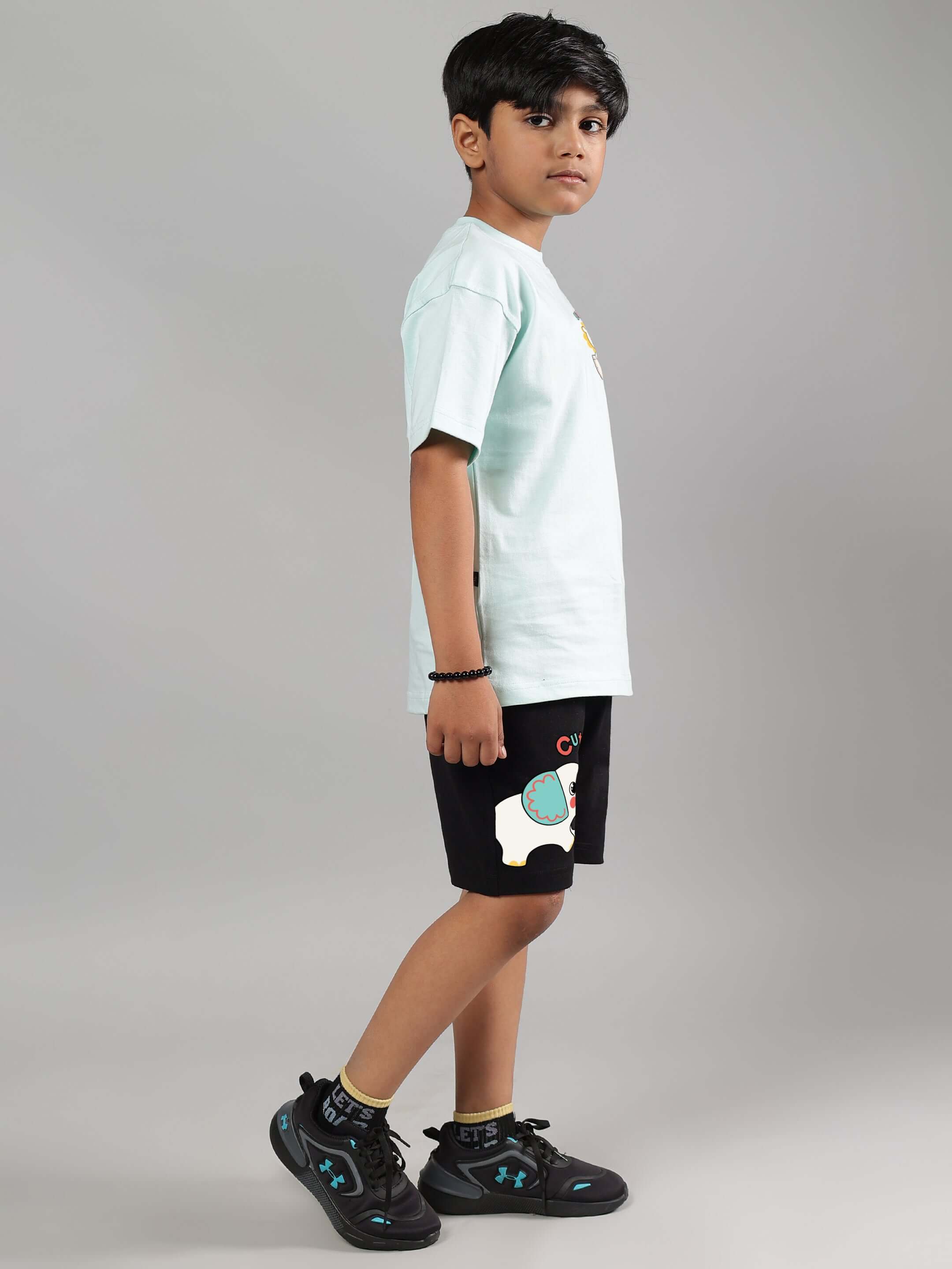 Child wearing black Cute Elephant Shorts suitable for boys and girls, featuring playful design. Made to order by DUDS.