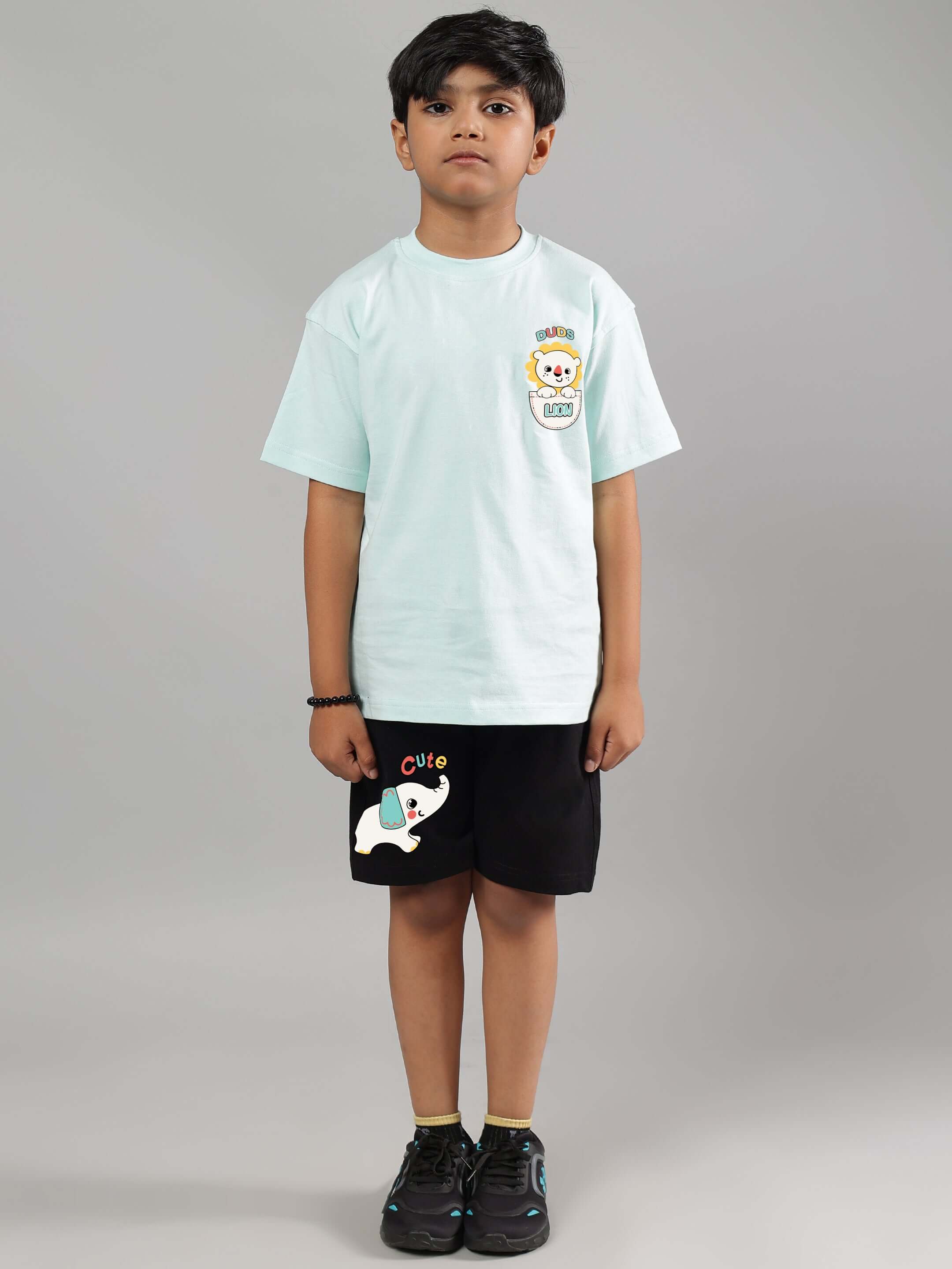 Child wearing black elephant shorts, ideal for boys and girls, with a light t-shirt, showcasing cute design and comfort from DUDS.