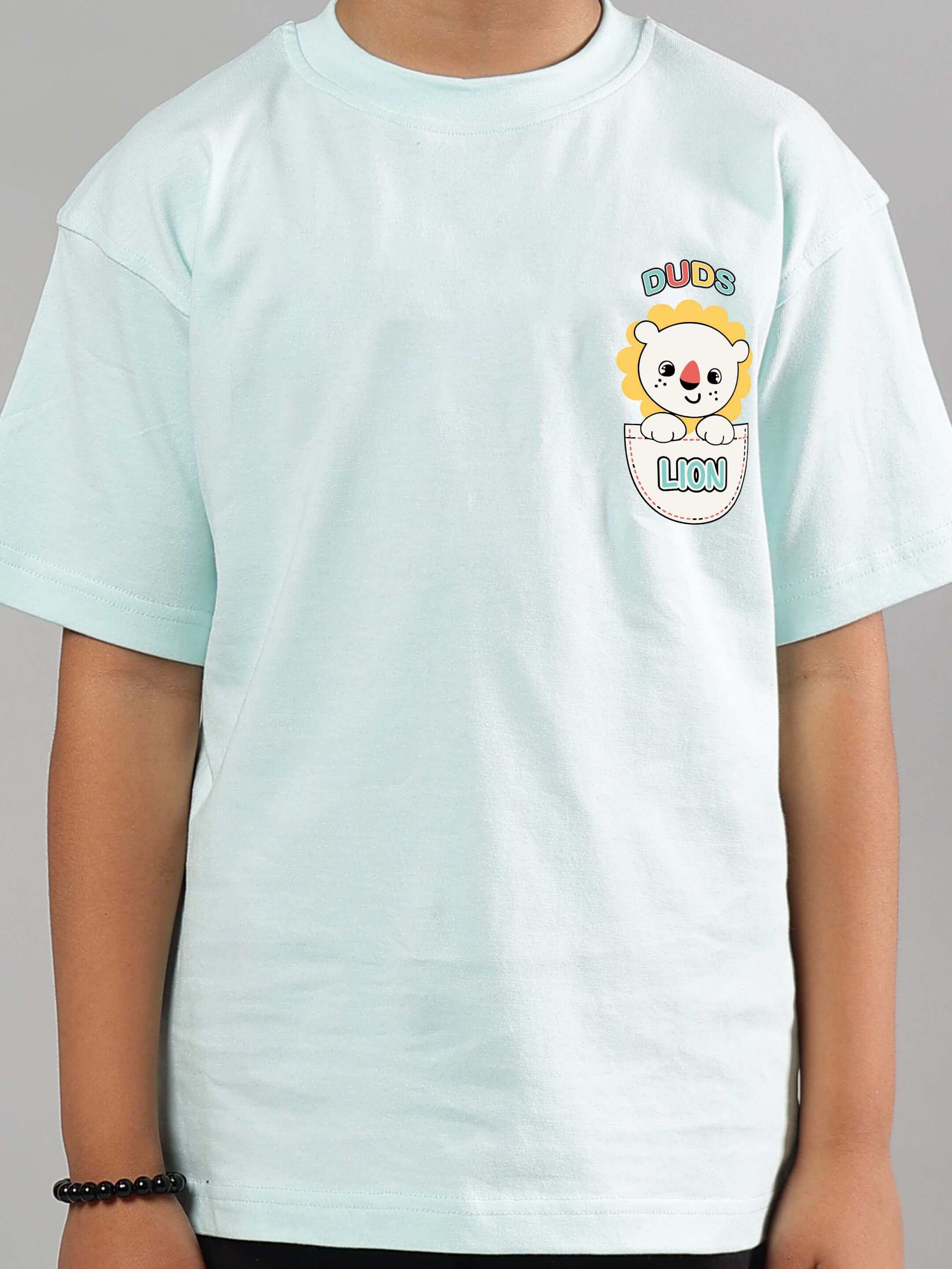 Child wearing a sky blue t-shirt featuring a cute cartoon pocket lion design by DUDS, suitable for boys and girls.