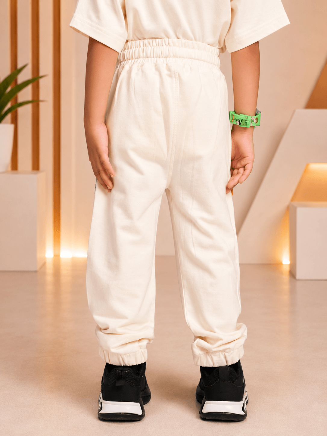 CUTE BLUE PUPPY PRINT CO-ORD FOR BOYS GIRLS OFF WHITE back view of kids outfit with cream joggers and black sneakers
