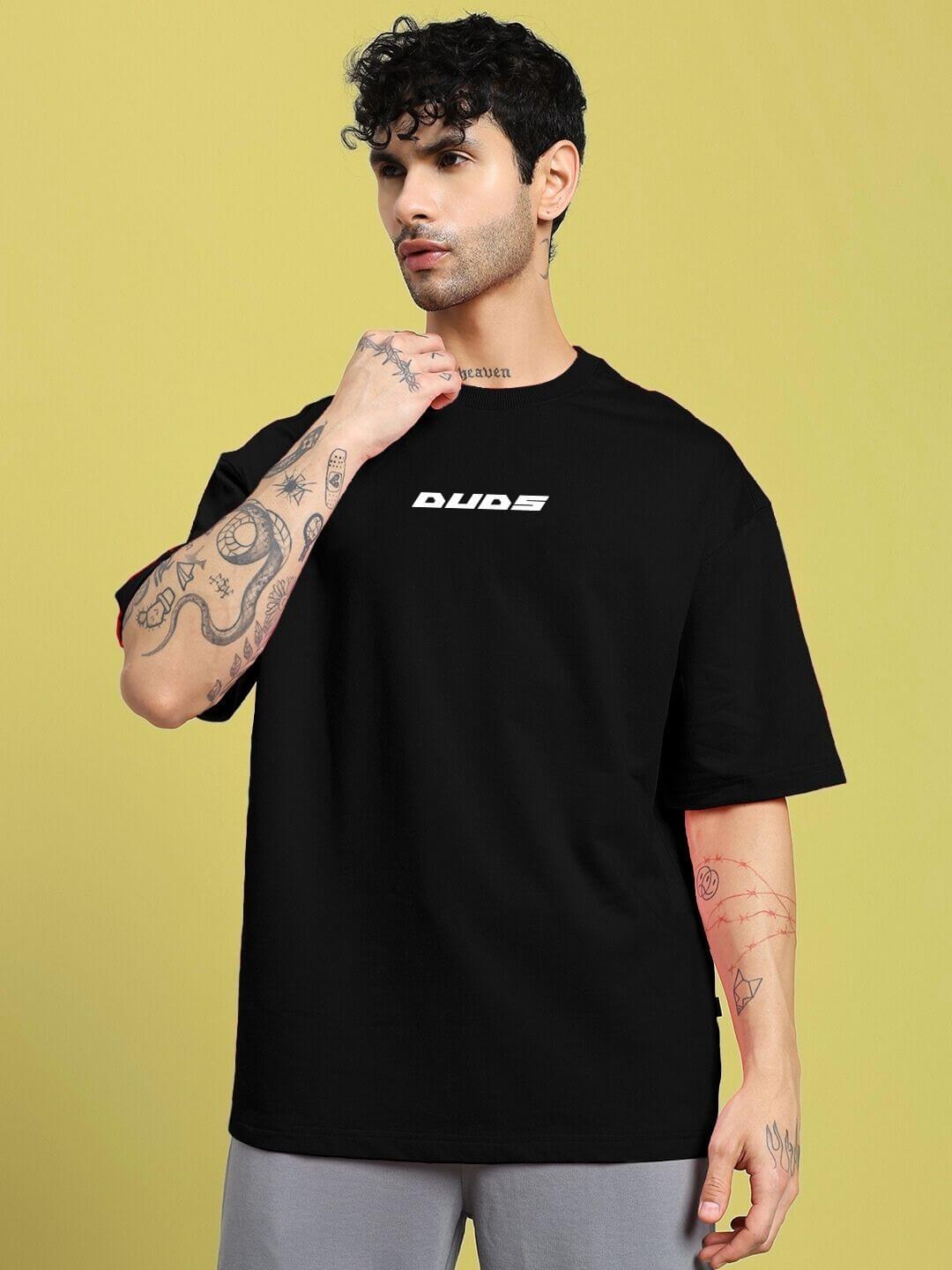 Man wearing CYBERPUNK OVER-SIZED T-SHIRT BLACK with bold graphic design embodying futuristic street style and comfort.