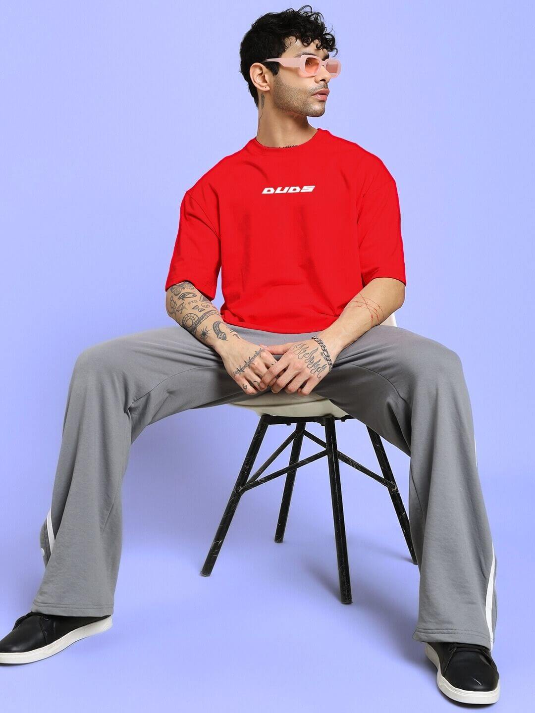 Model wearing CYBERPUNK OVER-SIZED T-SHIRT RED with futuristic style.