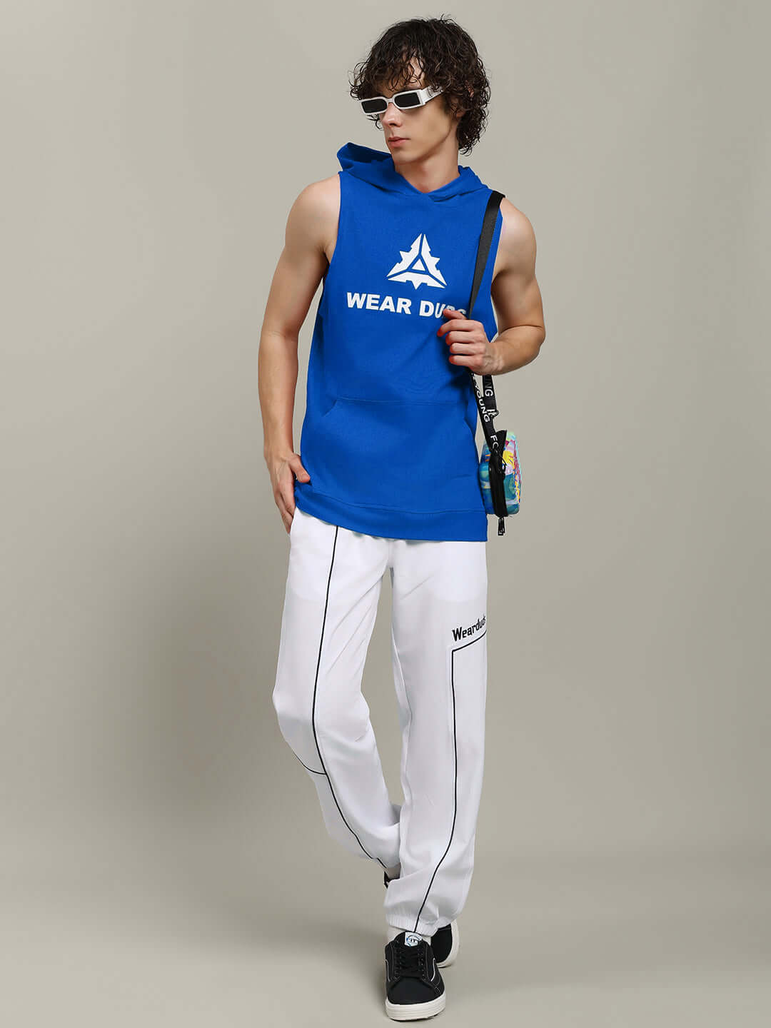 Man wearing CYBRAN GYM HOODED T-SHIRT BLUE with sunglasses, styled for streetwear