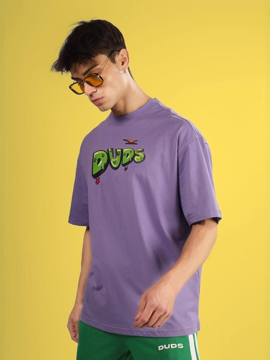 ESCAPED TWEETY OVER-SIZED T-SHIRT WISTERIA PURPLE worn by model with yellow sunglasses, featuring DUDS logo on chest.
