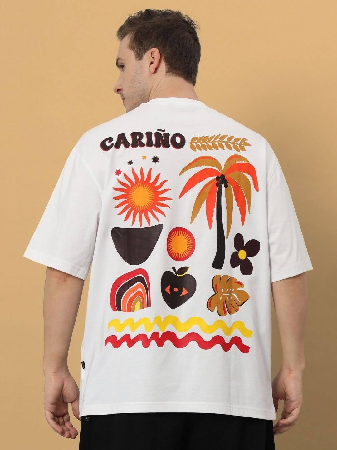 Back view of CARINO OVER-SIZED T-SHIRT WHITE with vibrant tropical prints.