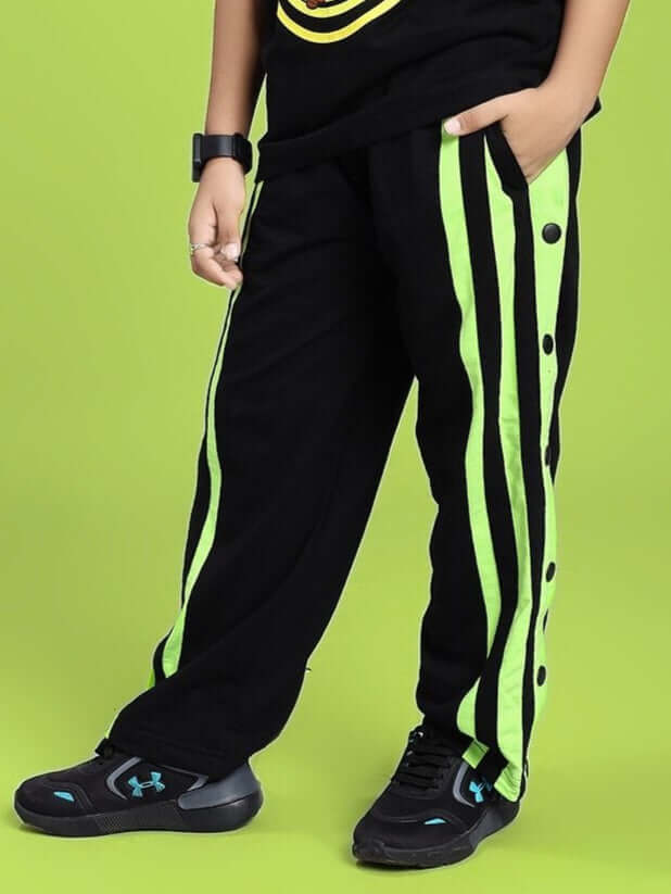 Child wearing DANCER JOGGER FOR BOYS AND GIRLS BLACK NEON-GREEN with bright neon-green stripes, showcasing comfortable and stylish kidswear.