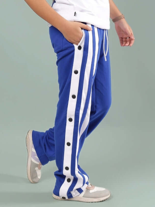Child wearing DANCER JOGGER FOR BOYS & GIRLS ROYAL BLUE with side stripes and buttons, customizable and made by DUDS Tailors.