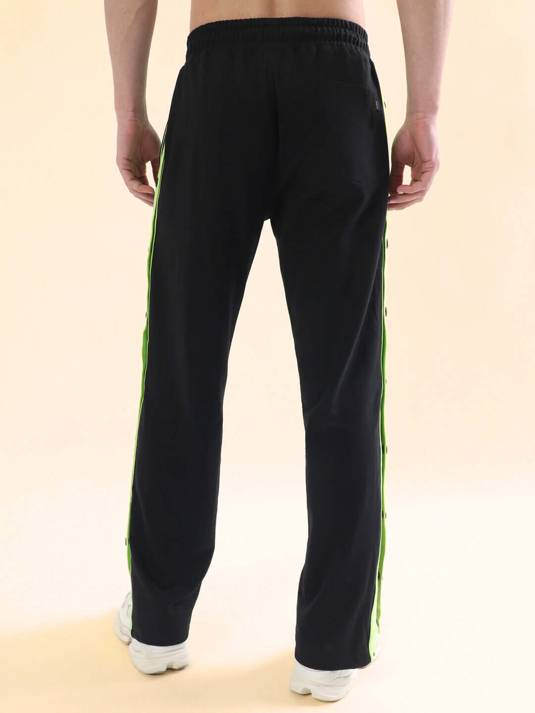 Back view of Dancer Joggers in black with neon green stripes, showcasing tailored fit made by DUDS tailors, available for custom fit.