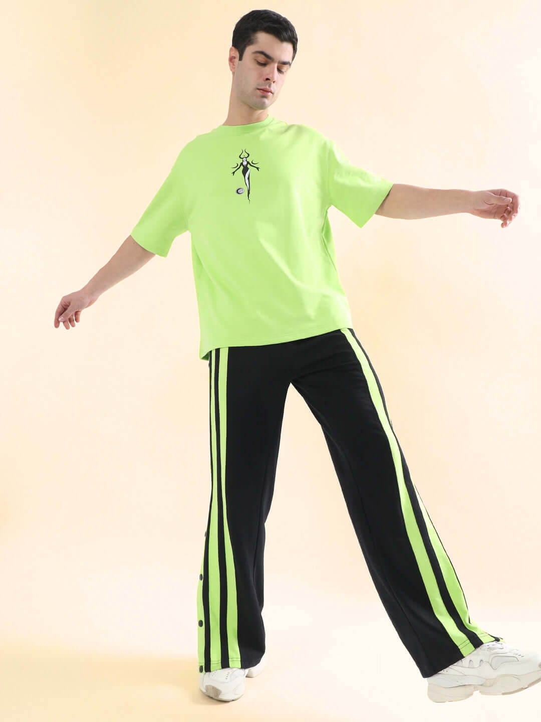 Model wearing black joggers with neon green stripes and matching neon green shirt, showcasing DANCER JOGGERS by DUDS.