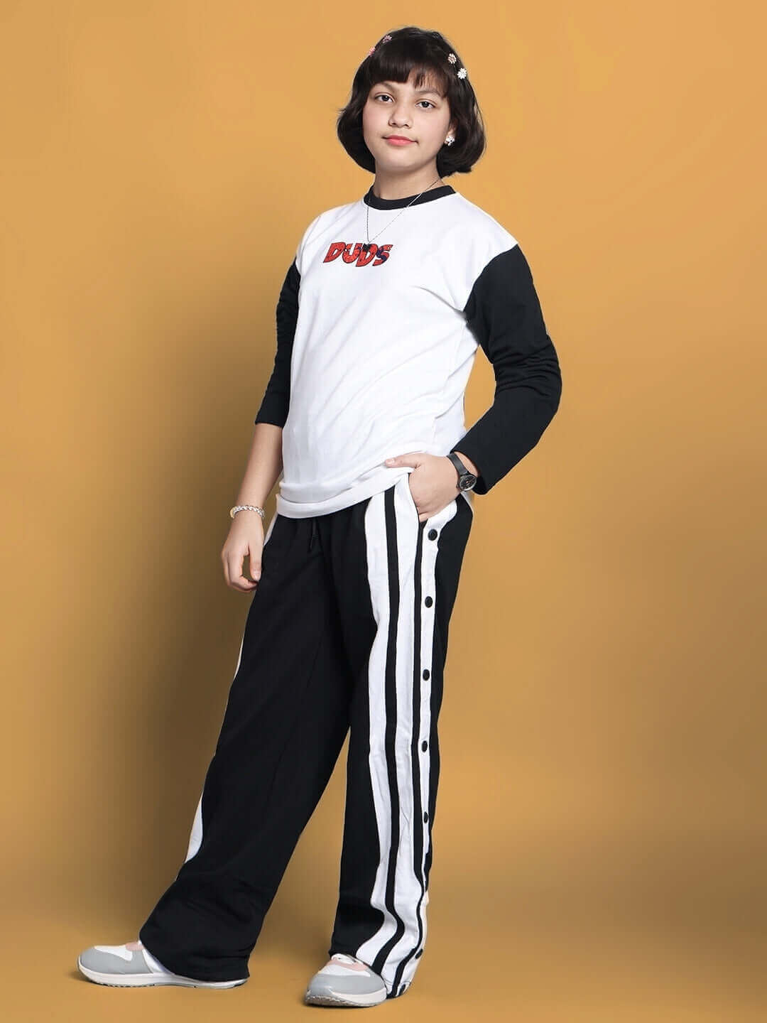 Child wearing Bitsy Co-Ord for Boys & Girls in white and black, showcasing a trendy and comfortable fit. Suitable for both genders.