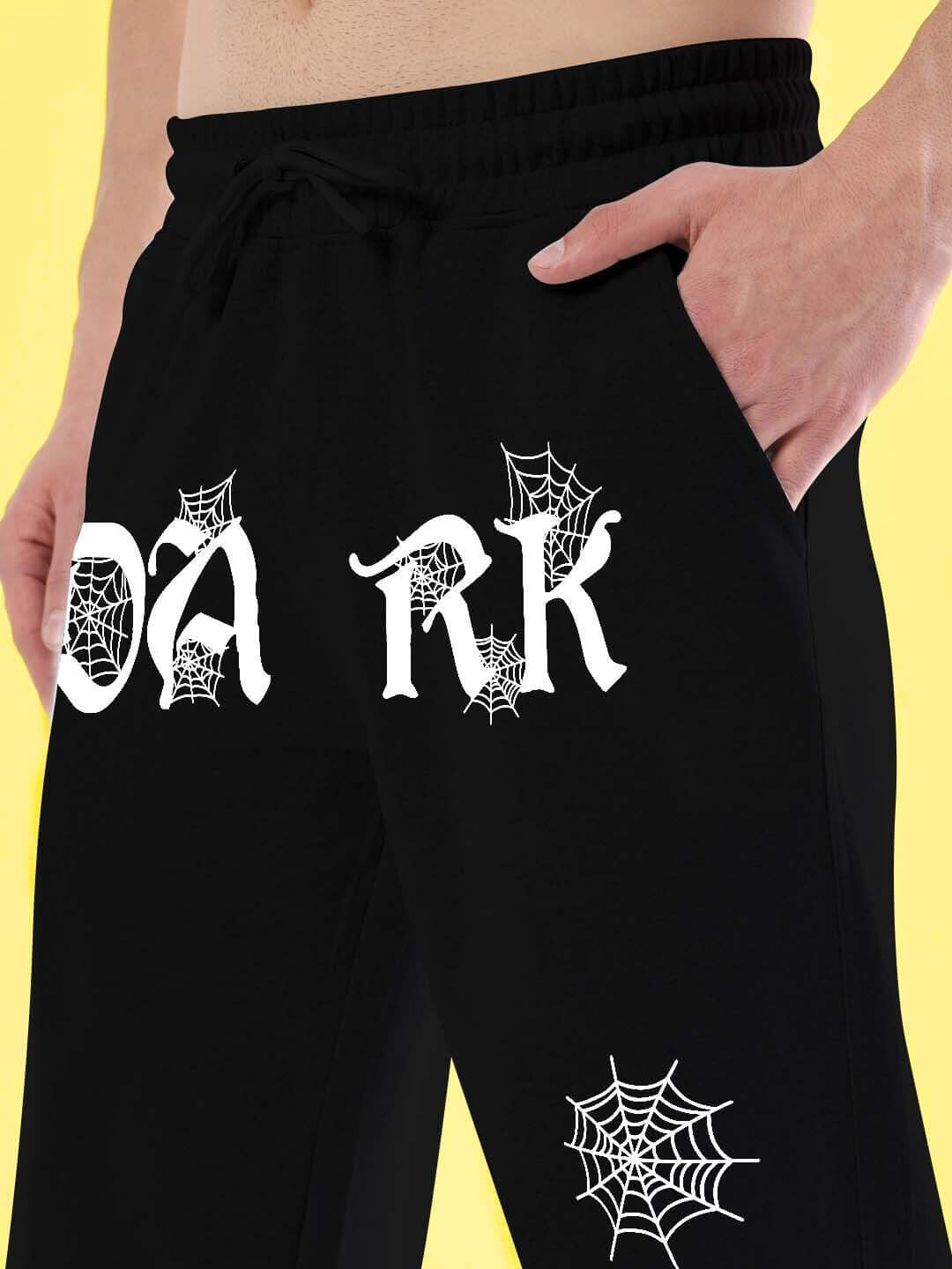 Black jogger with 'DARK' text and spider web design, relaxed fit, customizable sizing, made to order by DUDS.