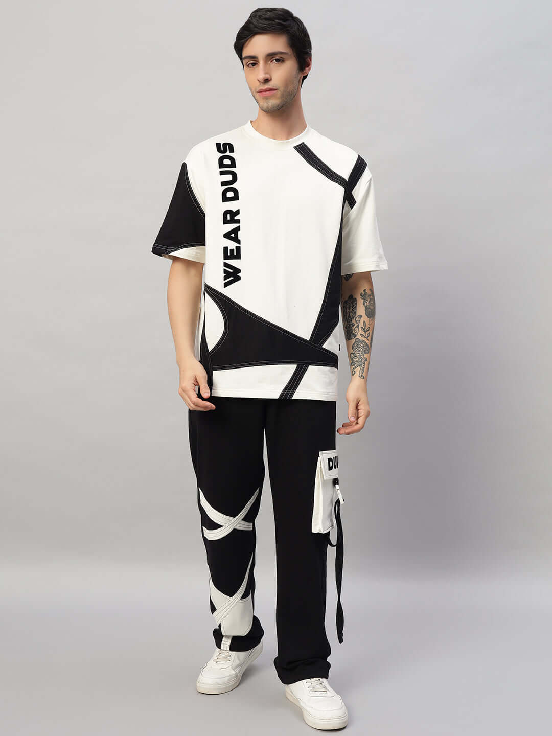 Model wearing DAVID OVERSIZED CO-ORD SET in off white and black, featuring relaxed fit joggers and T-shirt with elasticated waistband.