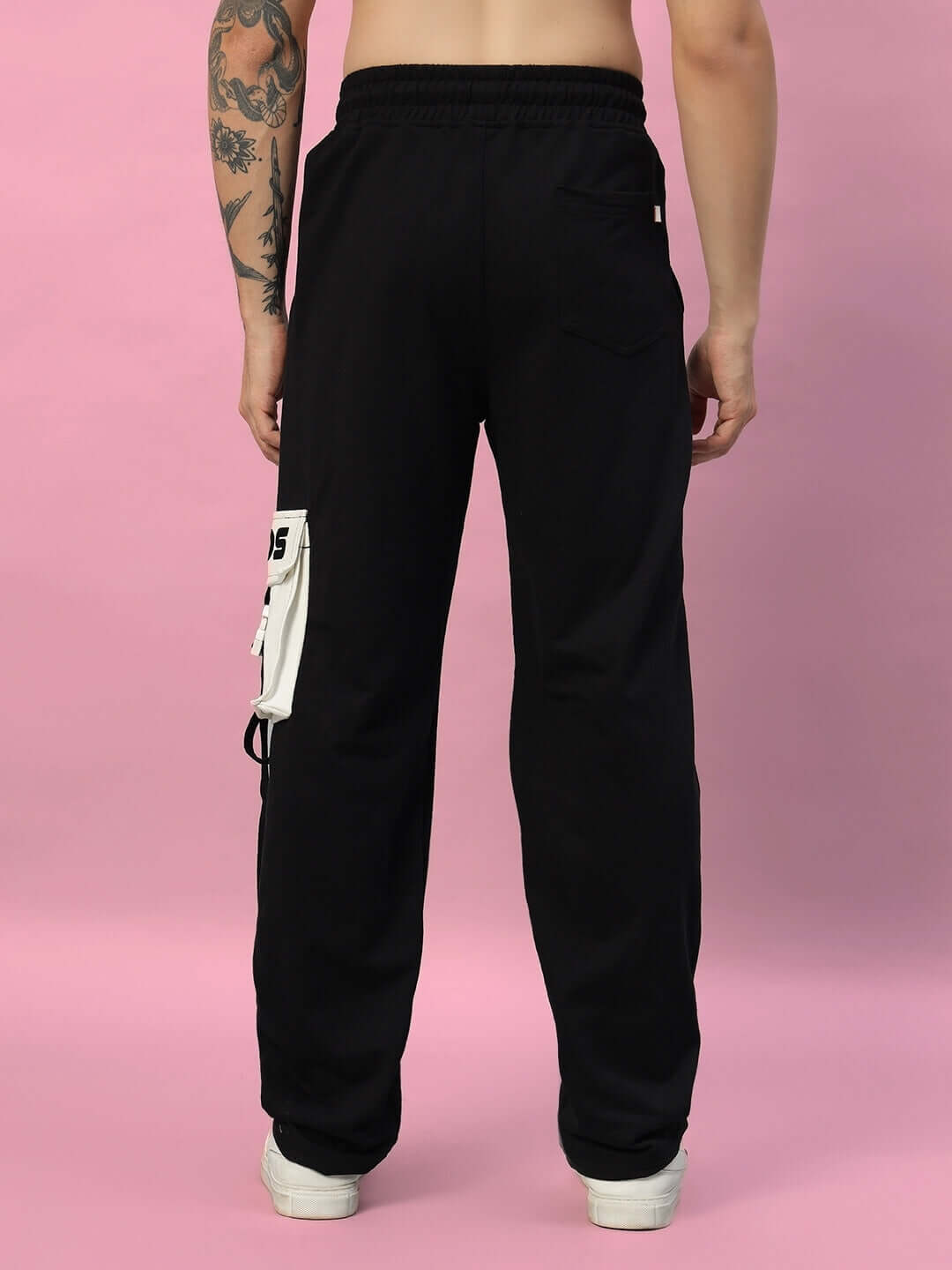 Rear view of DAVID JOGGER in black with side pocket detail, worn by male model on pink background. Made to order by DUDS.