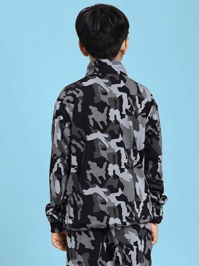 Child wearing DEFENCE CAMOFLAUGE JACKET FOR BOYS AND GIRLS BLACK GREY, featuring a black and grey camouflage design.
