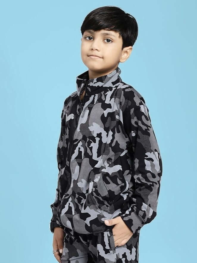 Boy wearing DEFENCE CAMOFLAUGE JACKET FOR BOYS AND GIRLS BLACK GREY with a blue background