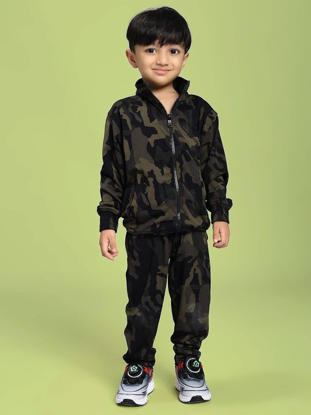 DEFENCE CAMOFLAUGE JACKET FOR BOYS AND GIRLS CAMO GREEN - Youth wearing camo green jacket on green background.