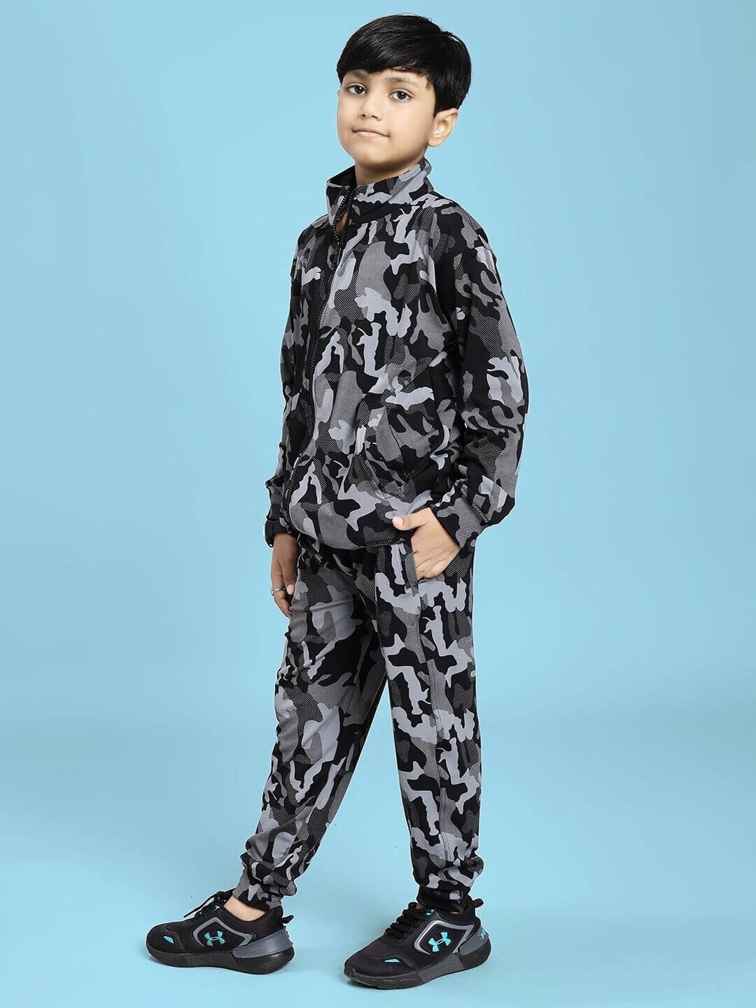 DEFENCE CO-ORD SET FOR BOYS AND GIRLS BLACK GREY - Child wearing camo-pattern tracksuit on blue background.