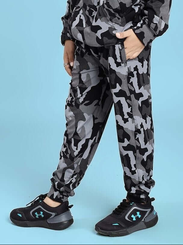 DEFENCE JOGGER FOR BOYS AND GIRLS BLACK GREY with camouflage design, shown worn by a child