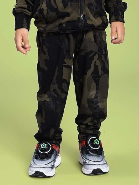 Child wearing DEFENCE JOGGER FOR BOYS AND GIRLS CAMO GREEN with running shoes.