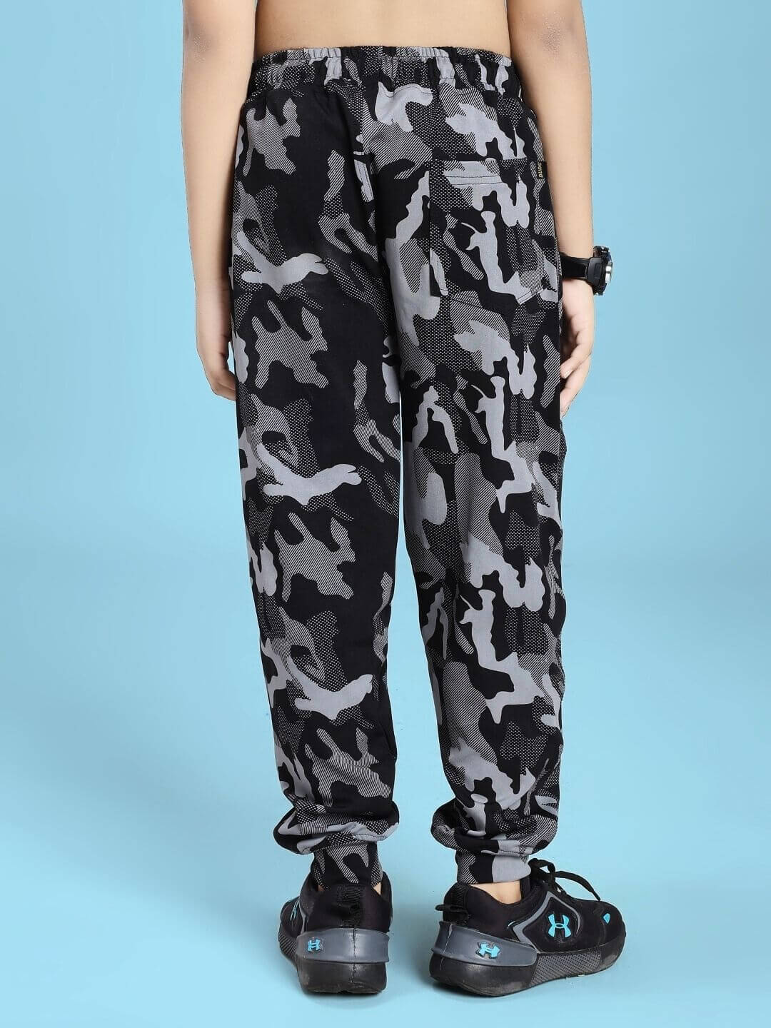 Back view of DEFENCE JOGGER FOR BOYS AND GIRLS BLACK GREY showing camouflage pattern on blue background.
