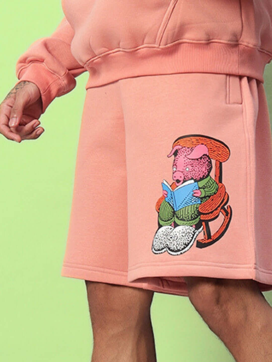 Person wearing Deliberate Fleece Shorts Peach with unique graphic design, showcasing cozy and stylish fleece material.