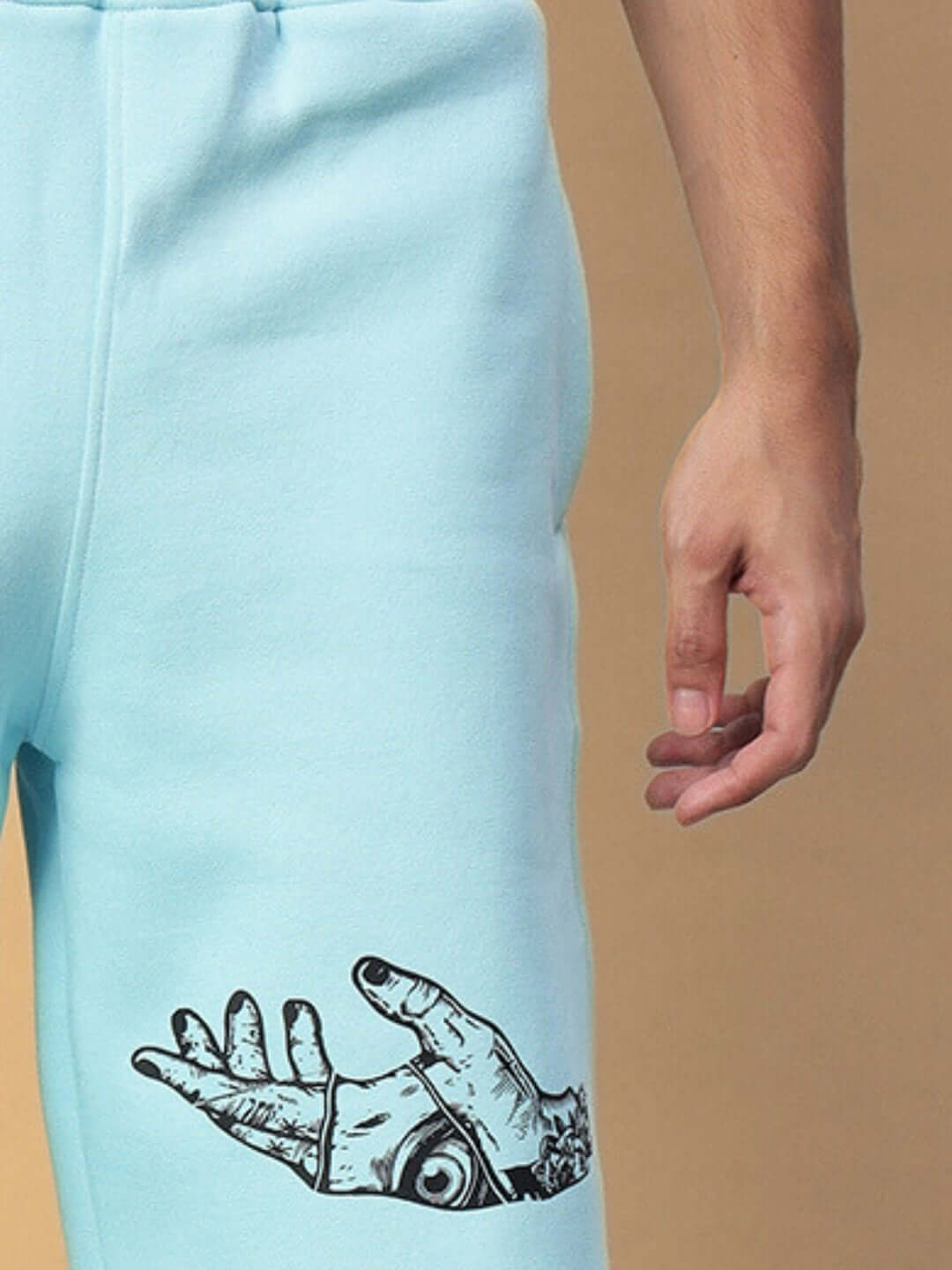 Close-up of WEARDUDS DEMON FLEECE CO-ORD SKY BLUE with hand design, showcasing tailored craftsmanship for custom fit options.