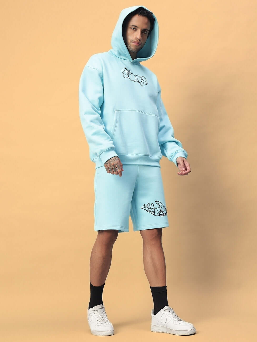 Model wearing WEARDUDS DEMON FLEECE CO-ORD SKY BLUE, featuring a hoodie and shorts, showcasing comfortable and stylish casual wear.