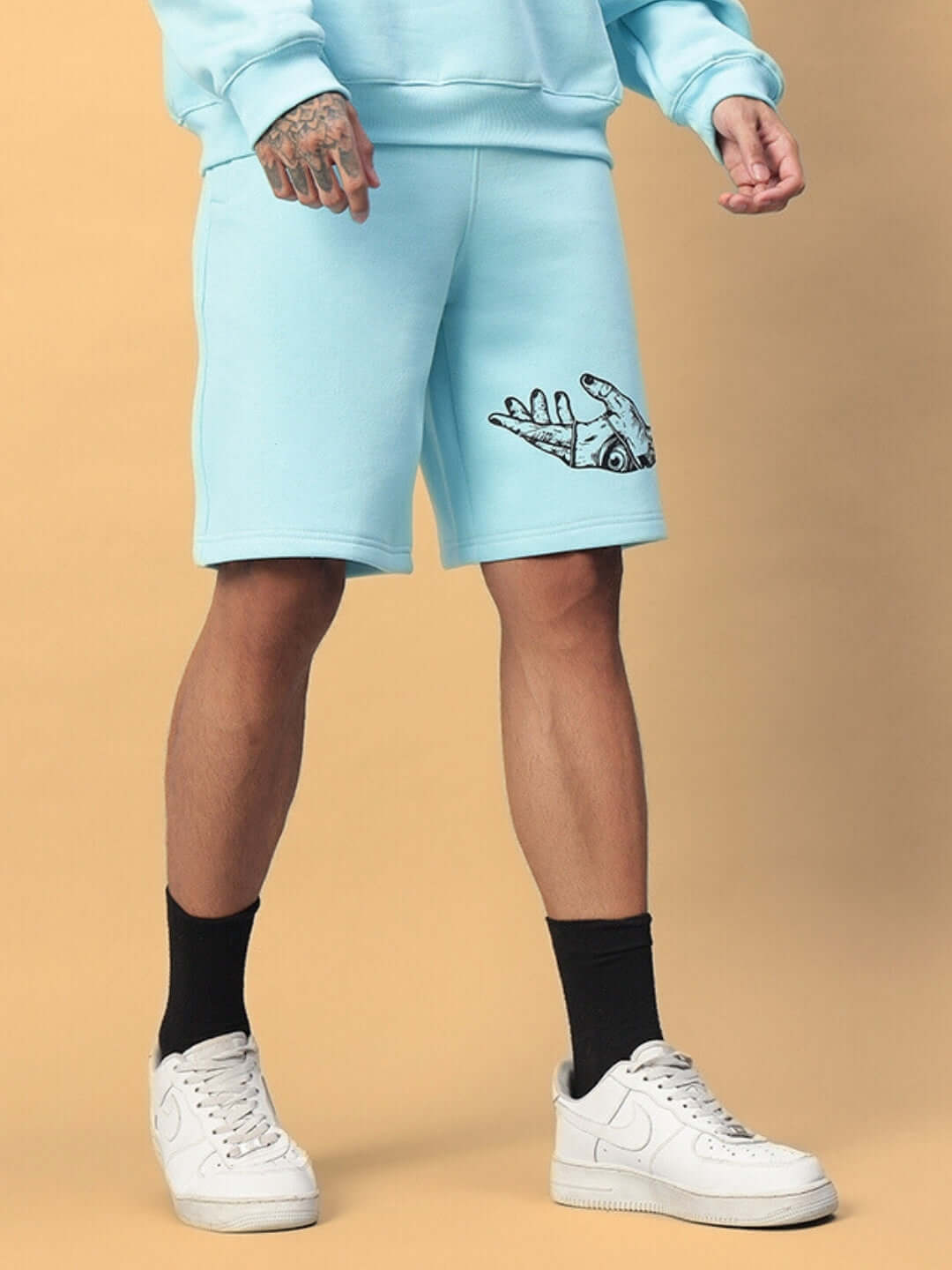 Person wearing WEARDUDS DEMON FLEECE SHORTS SKY BLUE with unique design, customizable fit, perfect for style and comfort.