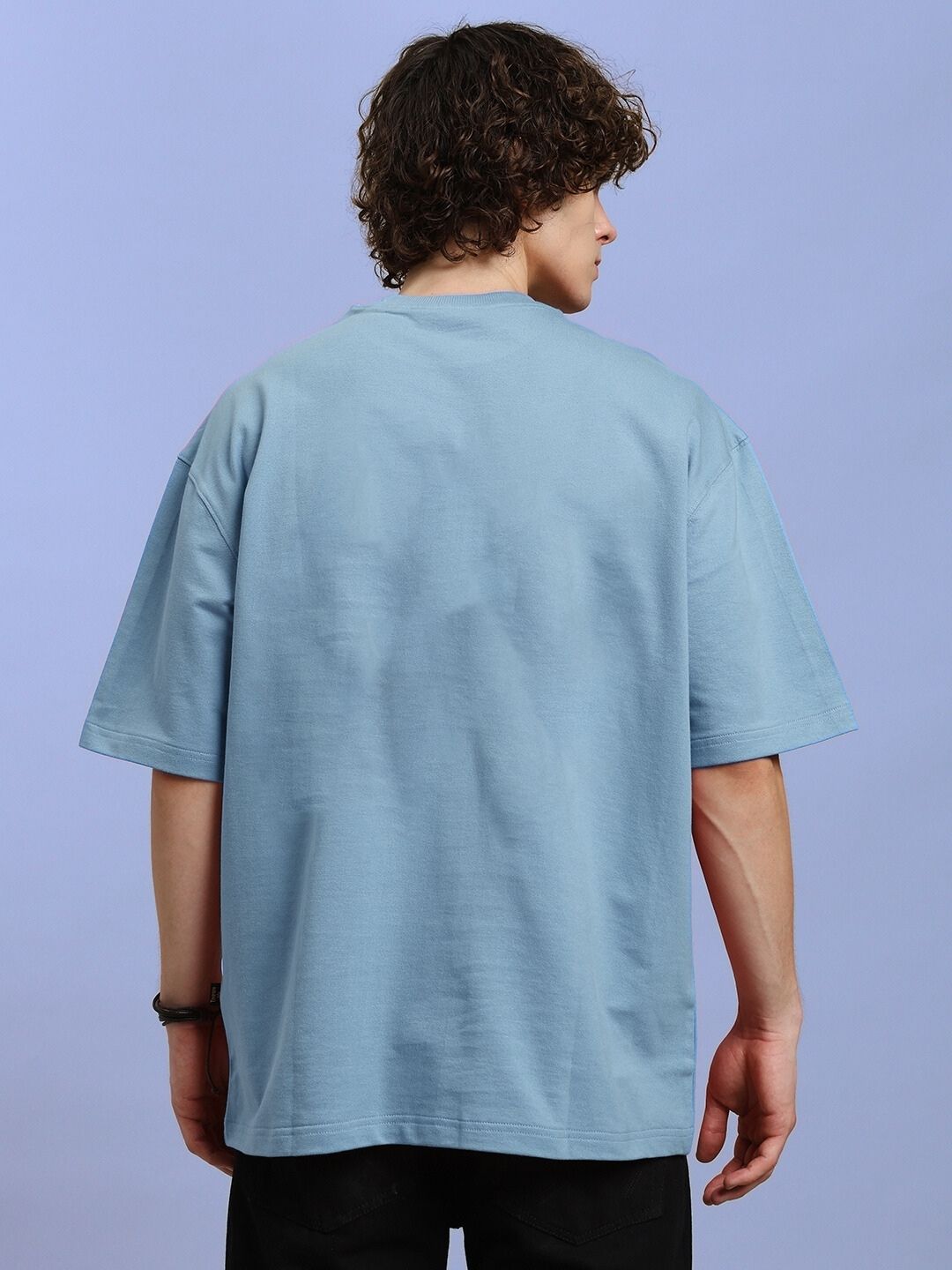 Back view of DEMON PRINTED OVER-SIZED T-SHIRT LIGHT BLUE showing design and fit on a person.