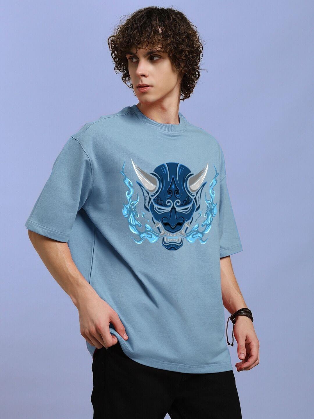 Model wearing DEMON PRINTED OVER-SIZED T-SHIRT LIGHT BLUE with demon graphic design, showcasing streetwear style.