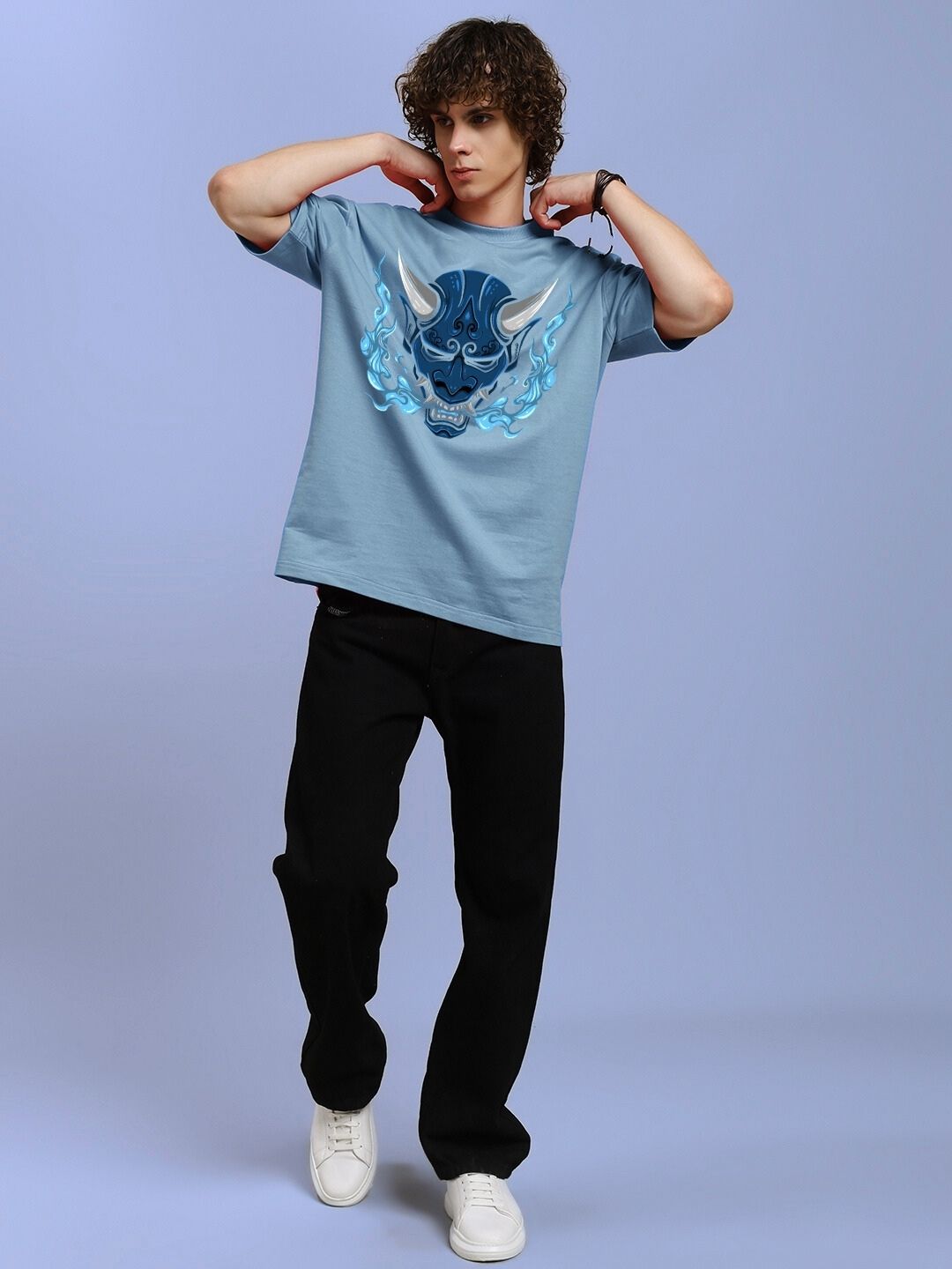 Man wearing DEMON PRINTED OVER-SIZED T-SHIRT LIGHT BLUE with demon graphic, standing in casual pose.