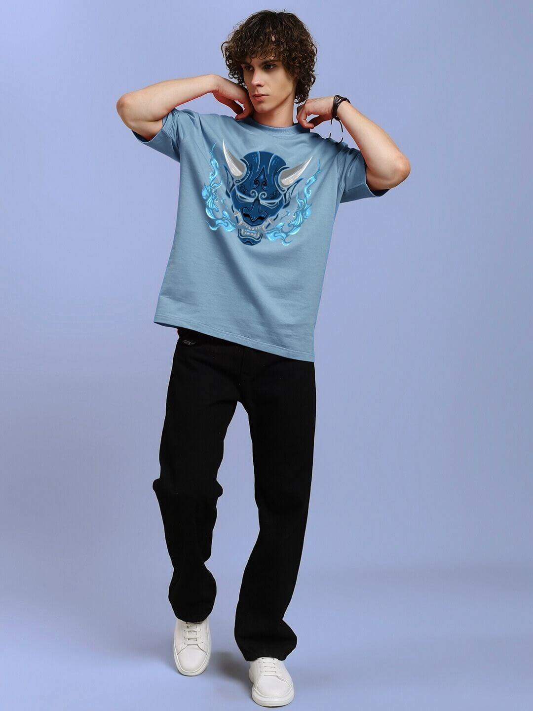 Model wearing DEMON PRINTED OVER-SIZED T-SHIRT LIGHT BLUE with striking demon graphic design