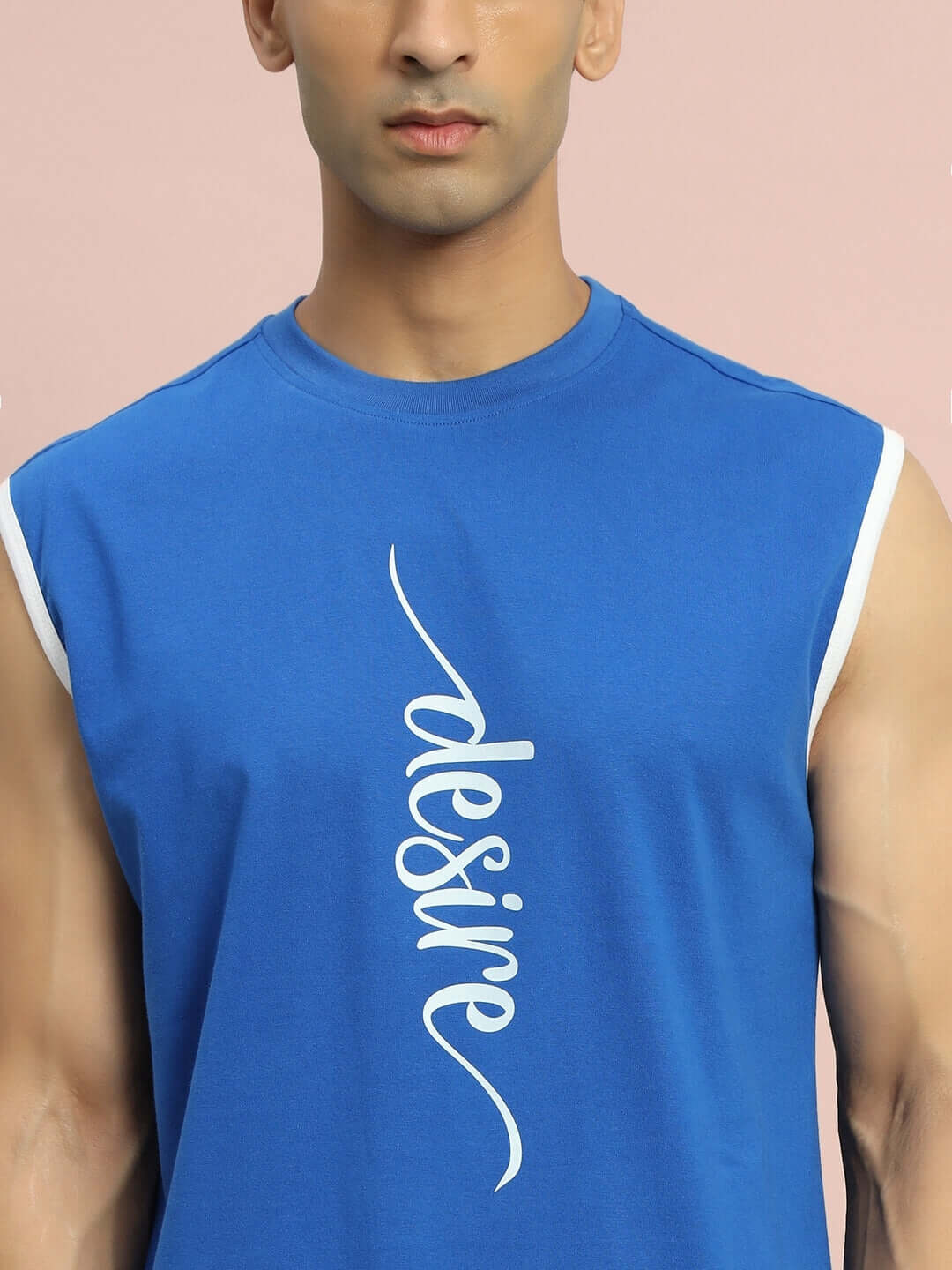 Man wearing Desire Gym T-Shirt in royal blue with custom fit options, featuring bold white "desire" text on front.