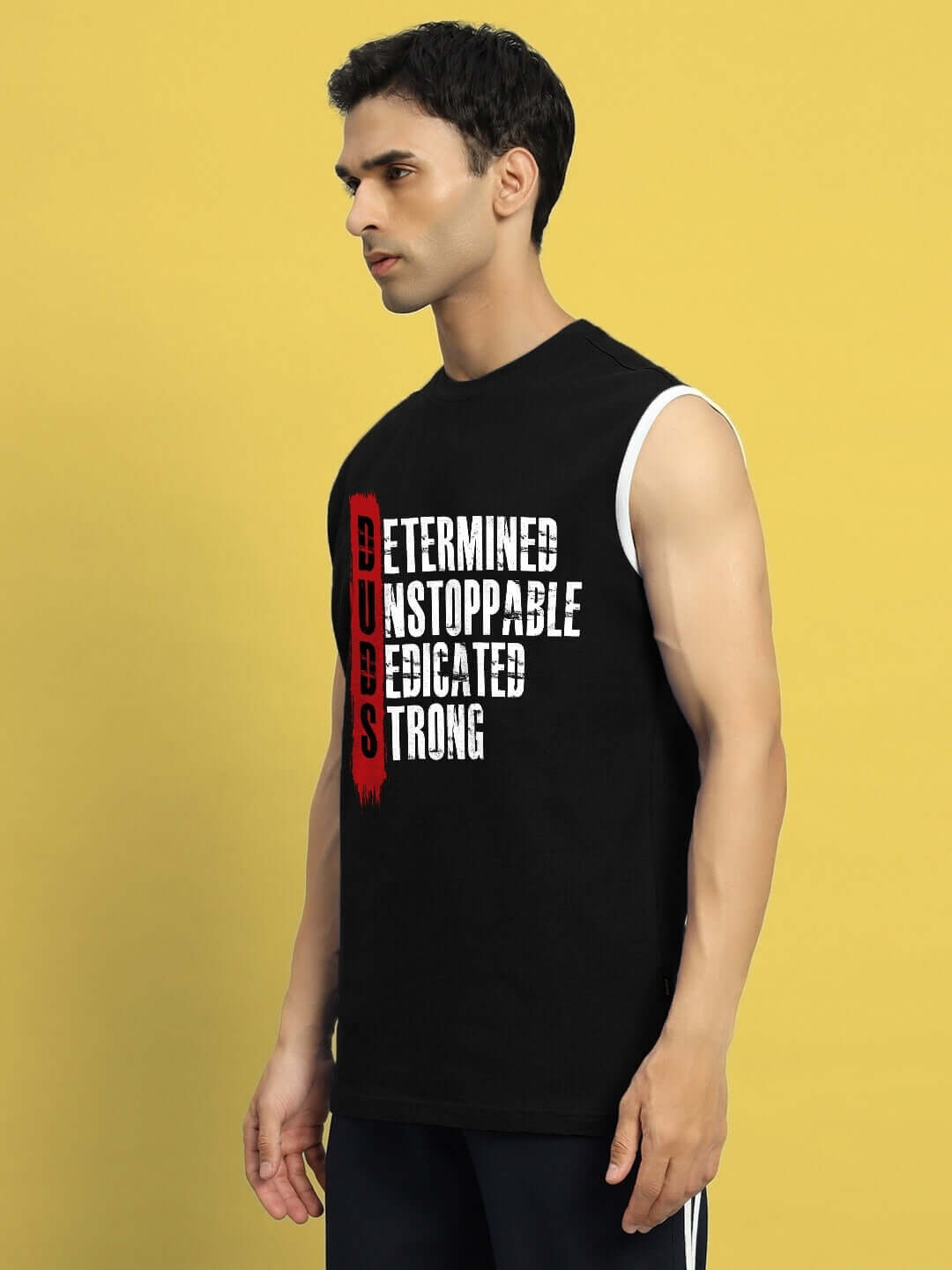 Man wearing DETERMINED PRINT GYM T-SHIRT BLACK with motivational words, suitable for custom fit orders