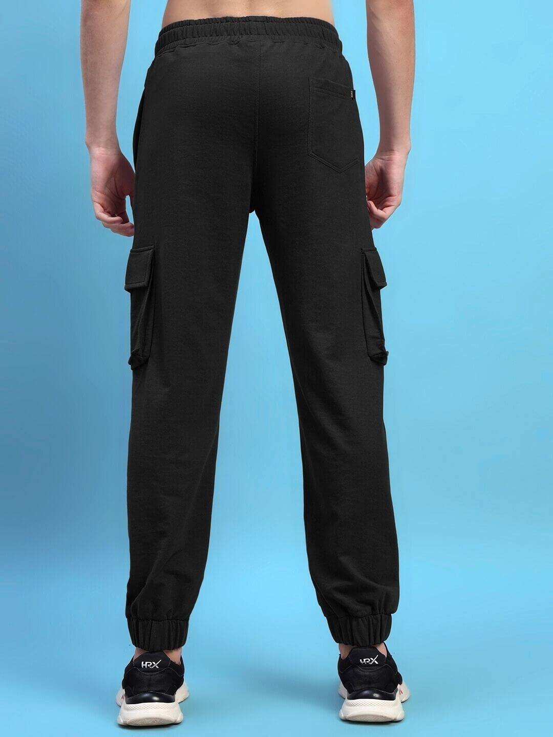 Back view of black DEVENO relaxed-fit joggers highlighting pockets and cuffed ankles. Tailored for comfort by DUDS. Custom fit available.