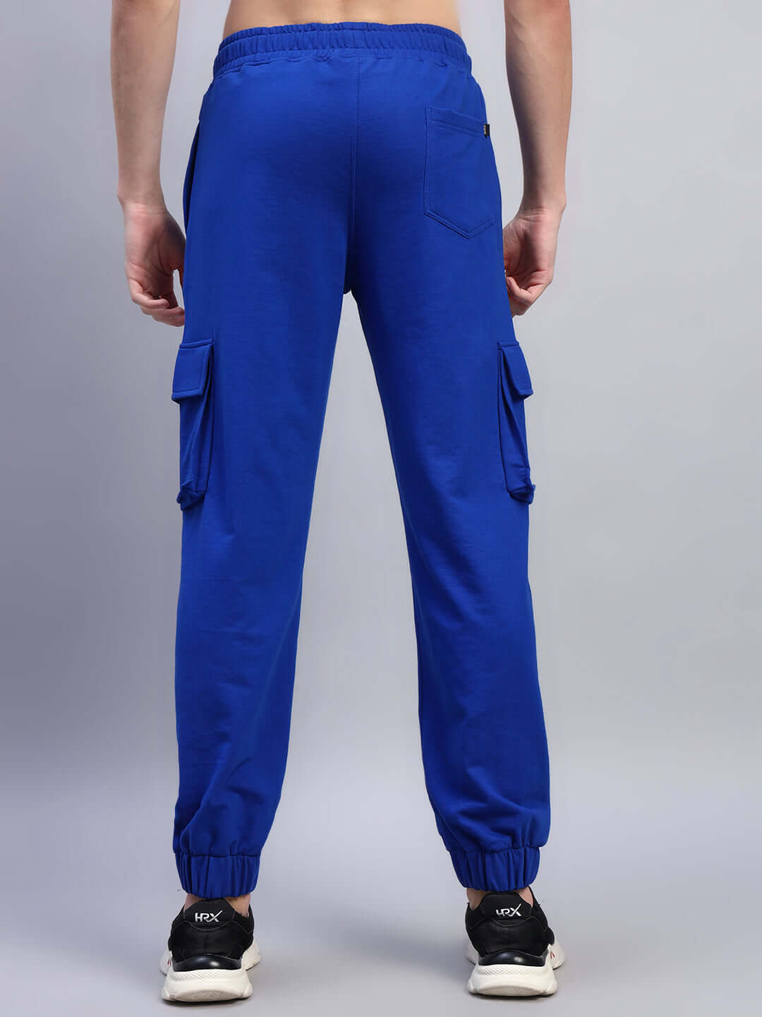 Back view of DEVENO RELAXED-FIT JOGGERS BLUE showcasing relaxed silhouette and striking color.