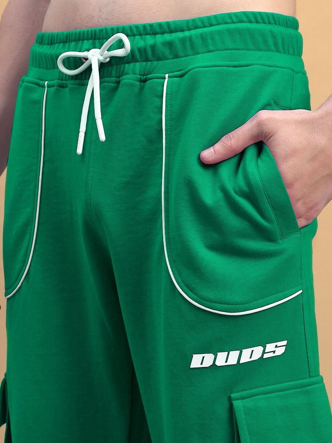 Close-up of DEVENO RELAXED-FIT JOGGERS GREEN with elastic waistband and drawstring, showcasing pocket detail and premium cotton blend.