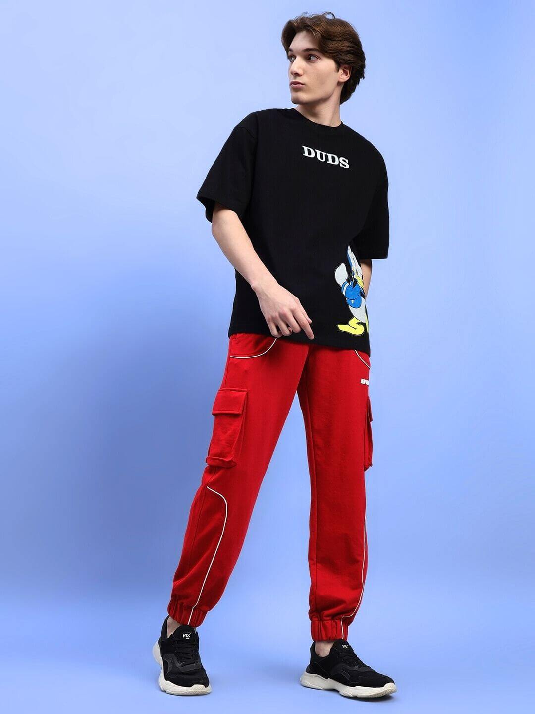 Model wearing DEVENO RELAXED-FIT JOGGERS RED, featuring casual style with black sneakers and matching top.