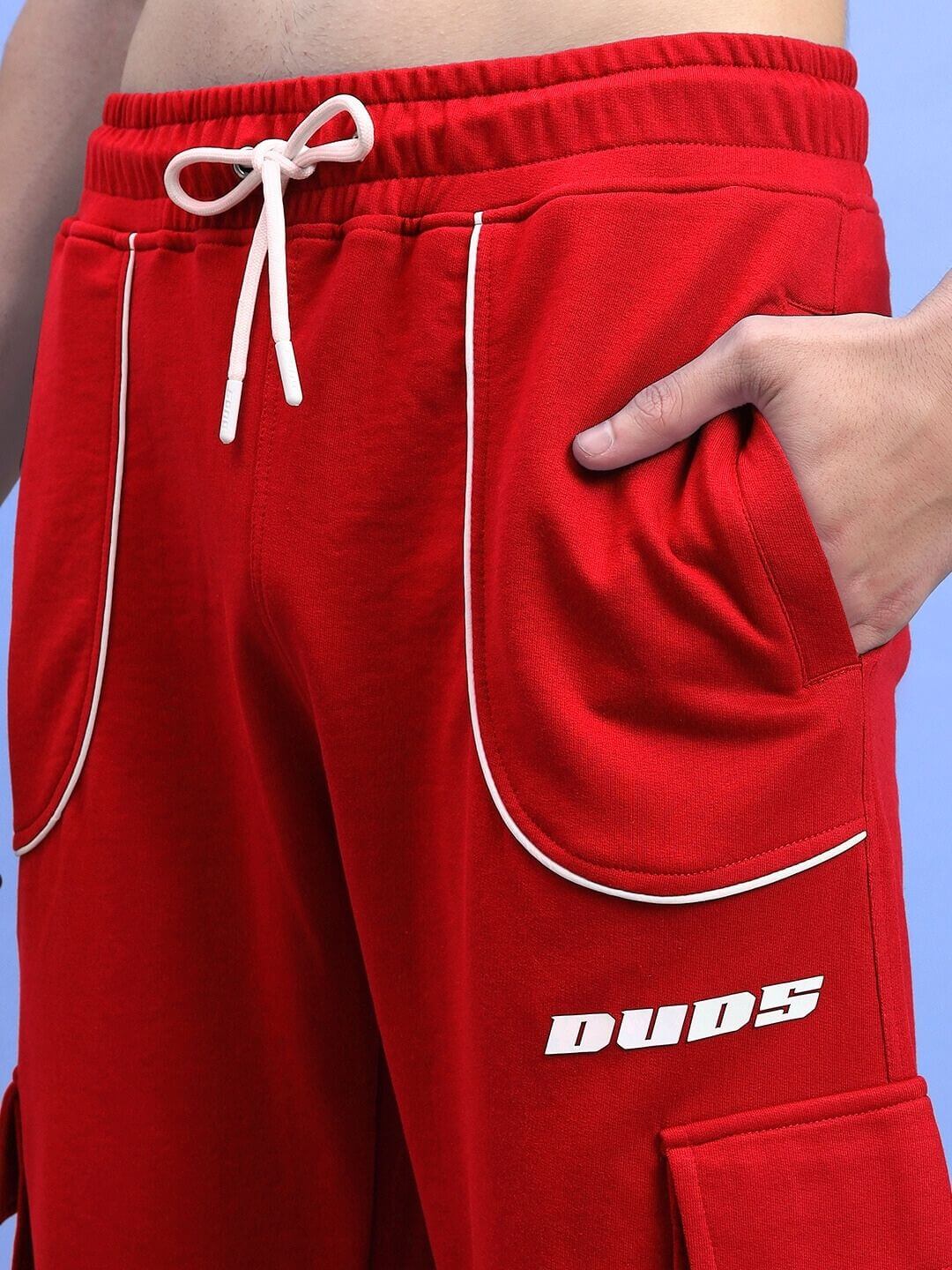 Close-up of DEVENO RELAXED-FIT JOGGERS RED with drawstrings and side pockets.