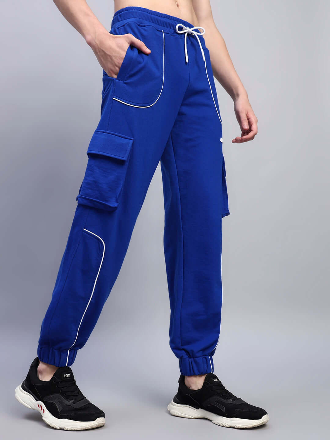 Person wearing DEVENO RELAXED-FIT JOGGERS BLUE with sneakers, showcasing a stylish and comfortable design perfect for casual outings.