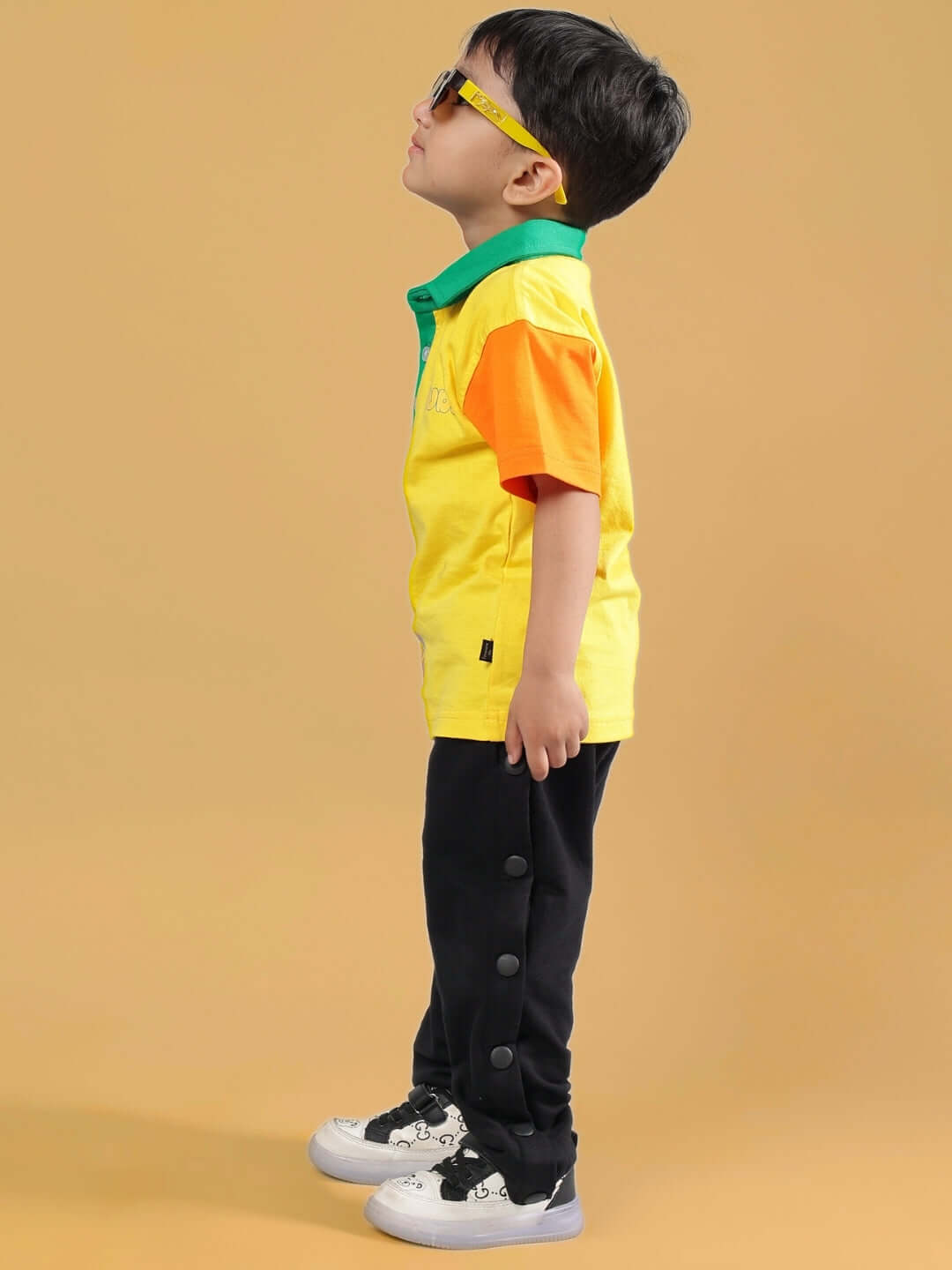 Child wearing DIBRU CO-ORD FOR BOYS & GIRLS YELLOW-BLACK with sunglasses, showcasing stylish fashion.