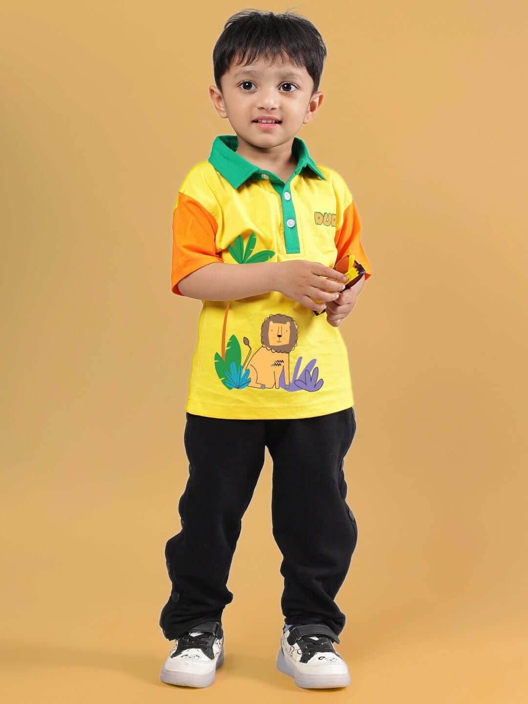 Child wearing DIBRU CO-ORD FOR BOYS & GIRLS YELLOW-BLACK outfit holding a toy