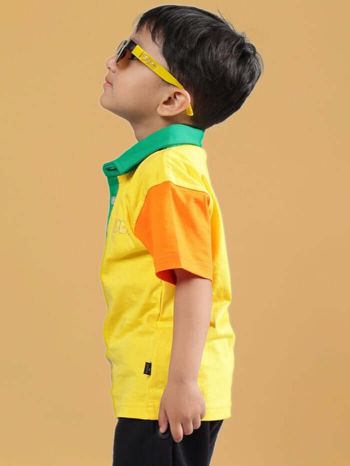 Young boy wearing DIBRU OVERSIZED T-SHIRT FOR BOYS & GIRLS YELLOW with sunglasses, showcasing vibrant colors and style for kids.