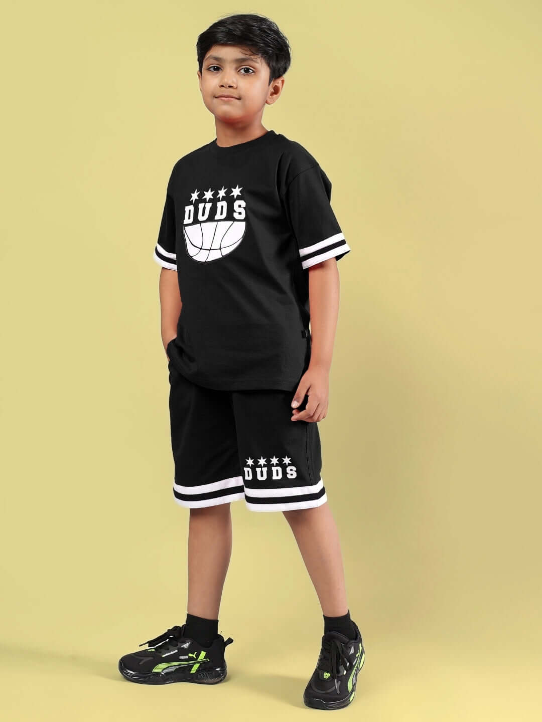 DIGGIN CO-ORD FOR BOYS & GIRLS BLACK outfit modeled by child, featuring DUDS logo and sporty style, custom fit available, made by experienced tailors.