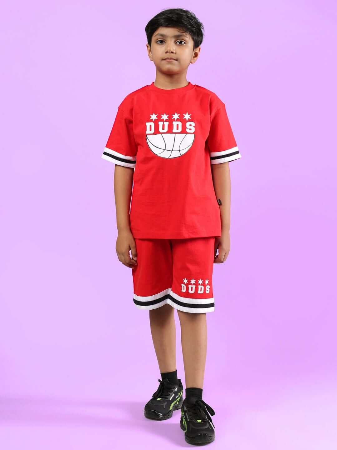 Child wearing red DIGGIN CO-ORD FOR BOYS & GIRLS by DUDS, featuring a sporty design with DUDS logo, ideal for both boys and girls.