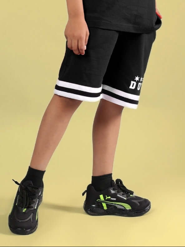 Child wearing DIGGIN SHORTS FOR BOYS & GIRLS BLACK, showcasing custom fit option by DUDS.