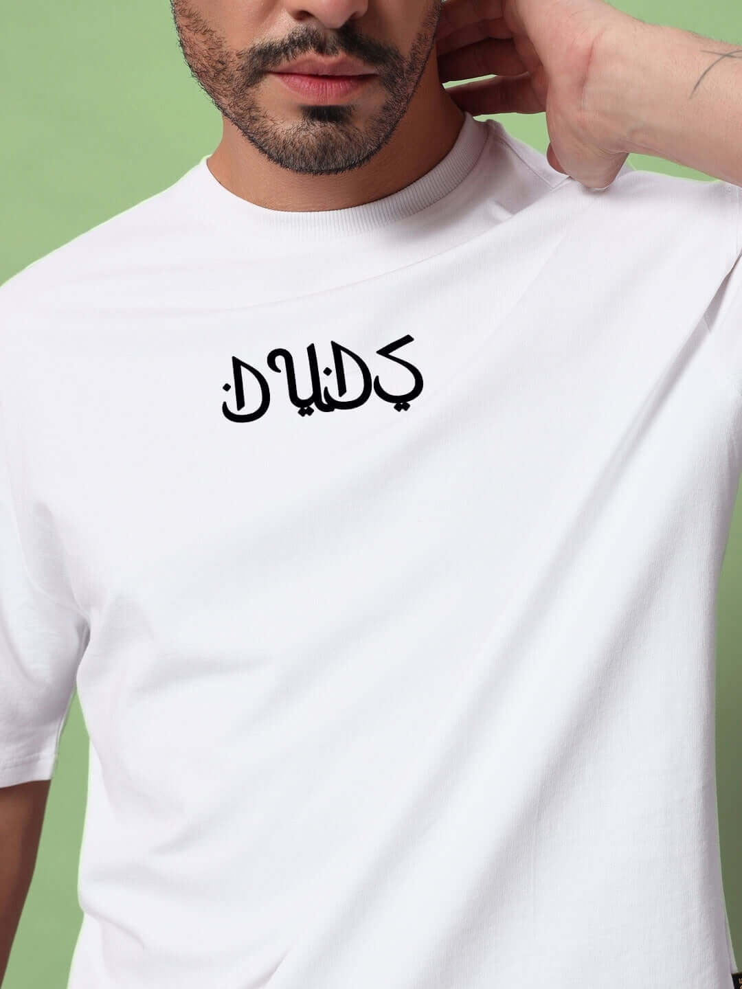 Model wearing DIMENSION OVER-SIZED T-SHIRT in white, made from premium heavy gauge fabric. Stylish and comfortable with unique design.